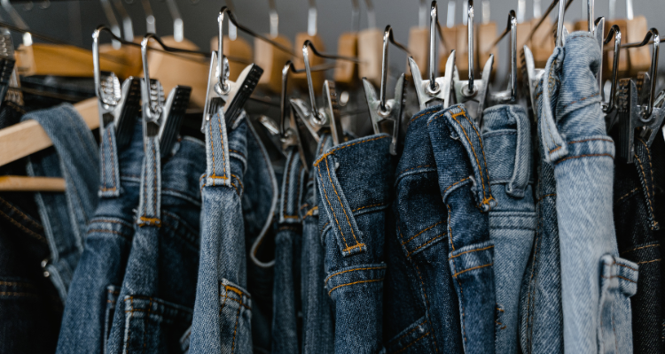 Denim pants hanging on a clothing rack