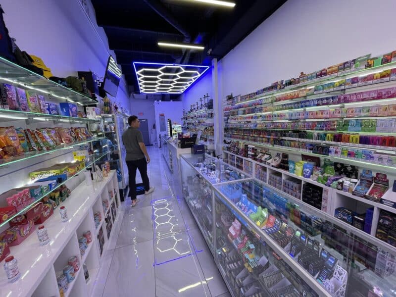 Gloss White Slatwall Panels Holding Product in a Smoke Shop