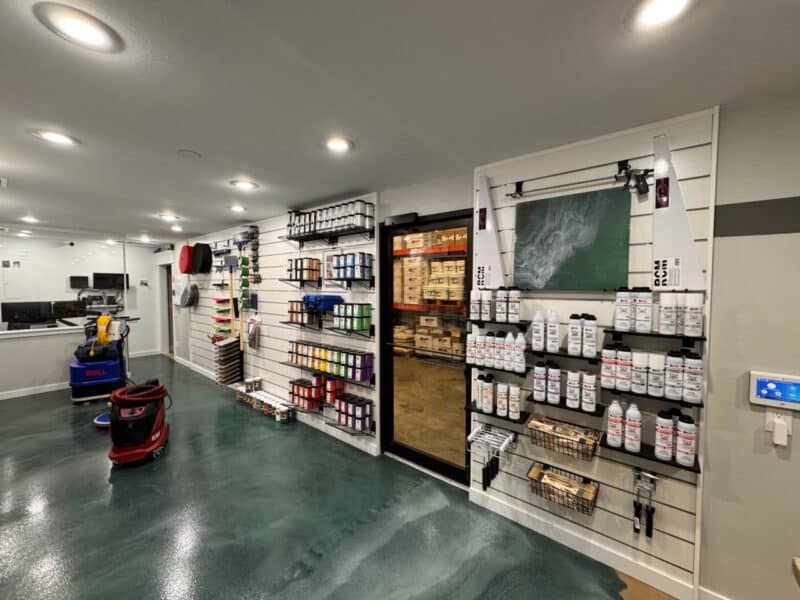 Matte White Slatwall Panels Holding Product in a Small Retail Store